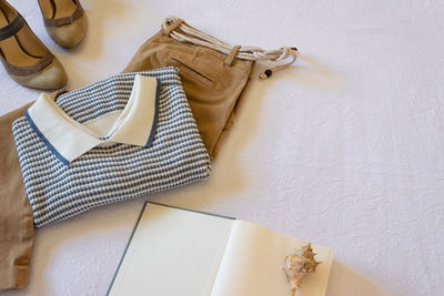High angle view of shoes on table against white wall