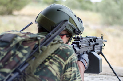 Close-up of man shooting rifle