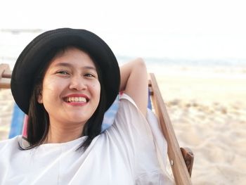 Portrait of smiling young woman on beach