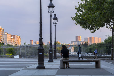 Low angle view of man standing on footpath