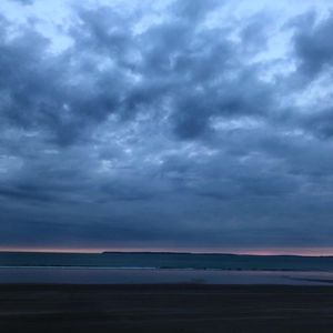 Scenic view of sea against dramatic sky