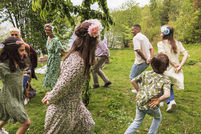 People dancing around midsummer maypole