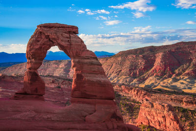 Rock formation against cloudy sky