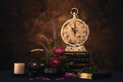 Close-up of illuminated clock on table