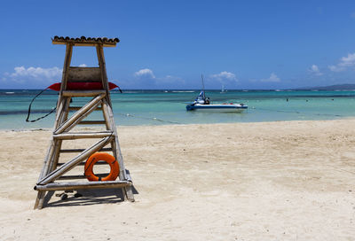 Lifeguard hut on beach against sky