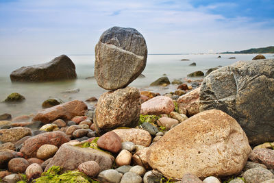 View of rocky beach against sky