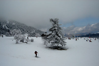 Tourists on snow covered mountain