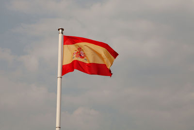 Low angle view of flag against sky