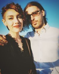 Portrait of smiling young couple standing outdoors