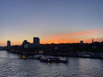 Bridge over river against sky during sunset