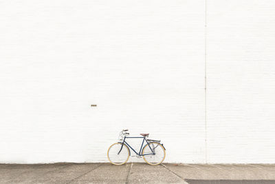 Bicycle parked against wall