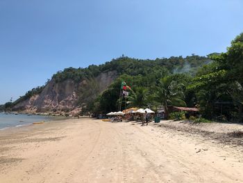 Scenic view of beach against clear blue sky