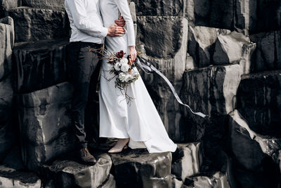 Midsection of woman standing on cross