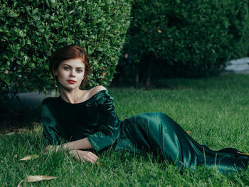 Portrait of beautiful young woman in grass