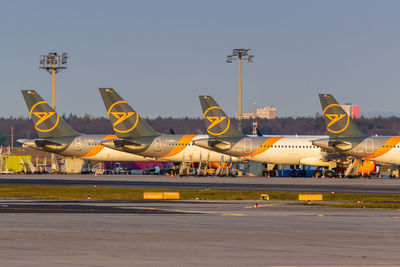 Airplane on airport runway against clear sky