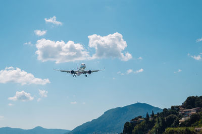 Low angle view of airplane flying against sky