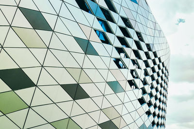 Low angle view of modern glass building against sky