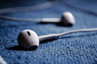 High angle view of headphones over fabric on table