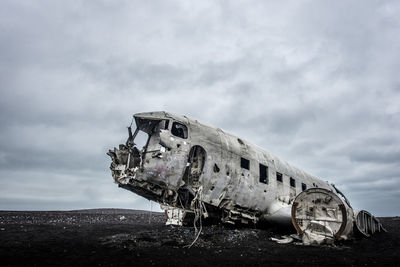 Abandoned airplane against sky