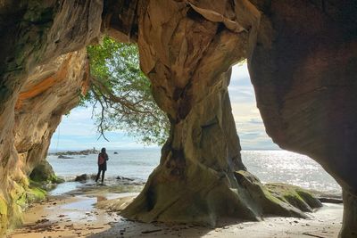 Scenic view of sea seen through rock formation