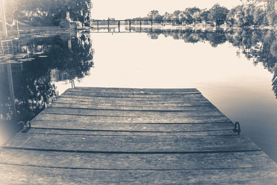 Pier over lake against clear sky