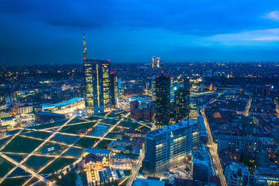 High angle view of illuminated cityscape against sky at night