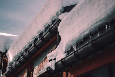 Low angle view of bicycle on snow covered landscape