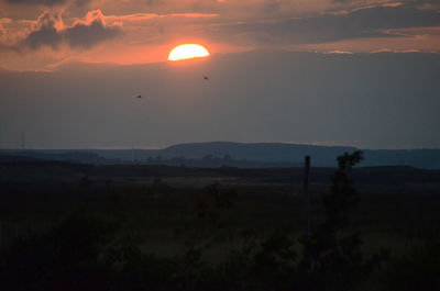 Scenic view of landscape at sunset