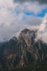 Scenic view of mountains against cloudy sky