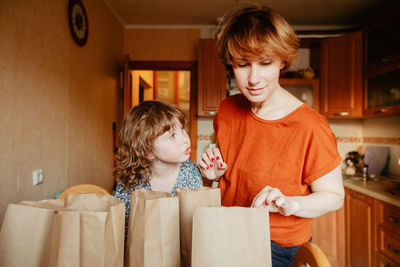 Happy siblings standing in box