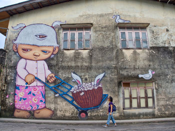 Full length of cute girl in window