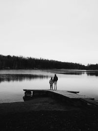 Calm lake with trees in background