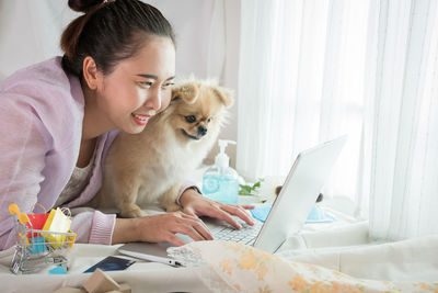 Young woman using laptop while sitting at home