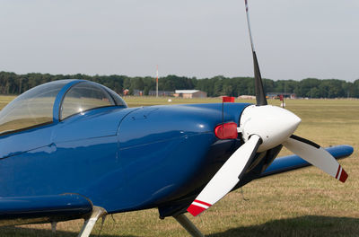 Close-up of airplane against blue sky