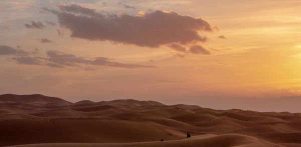 Scenic view of desert against sky during sunset