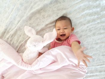 High angle view of cute baby lying on bed