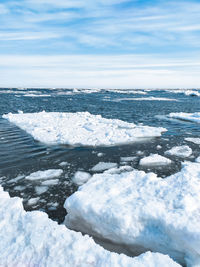 Scenic view of frozen lake against sky