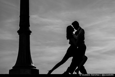 Low angle view of silhouette man against sky