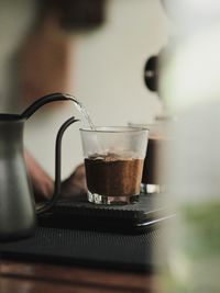 Close-up of hot water pouring in coffee cup