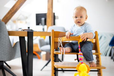 Portrait of cute boy playing with toy blocks