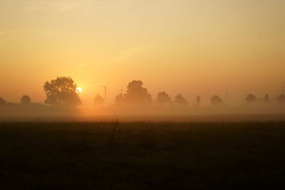 Scenic view of field against sky during sunset