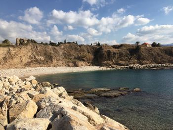 Scenic view of sea and rock formation against sky