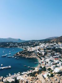 High angle view of townscape and sea against clear sky