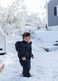 Full length of boy standing in snow