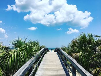 Steps amidst sea against sky