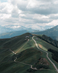 Aerial view of road by mountains against sky