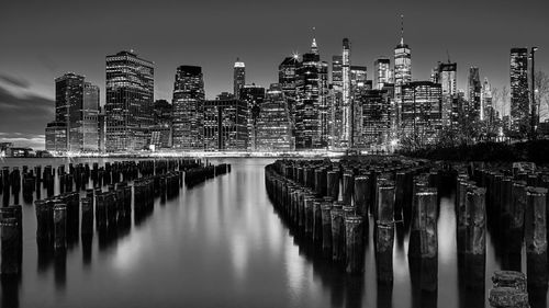 Reflection of illuminated buildings on water in city