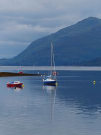 Boats in lake against sky