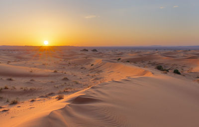 Scenic view of beach against sky during sunset