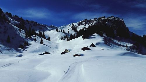 Scenic view of snow covered mountains against sky